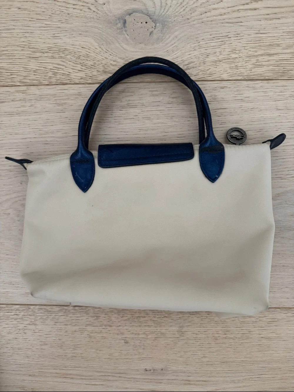 Longchamp Small Le Pliage Cream Tote with Navy Trim. Top zip with snap flap.